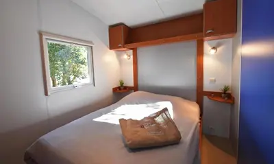 a small bedroom with a bed with a bag on it at U FARNIENTE in Bonifacio