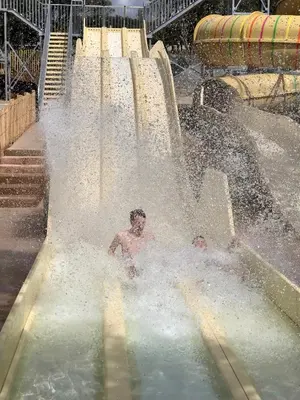 two boys playing in a water slide at a water park at U FARNIENTE in Bonifacio