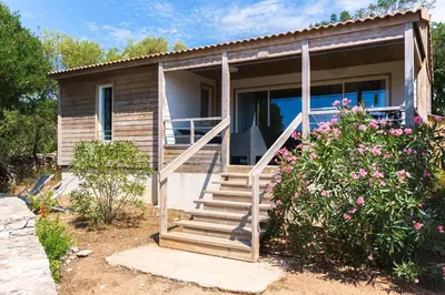 a small house with stairs leading to a porch at U FARNIENTE in Bonifacio