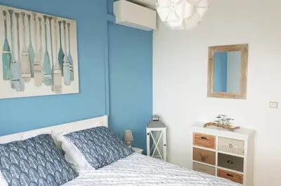a bedroom with a blue accent wall and a bed at Sole Rossu in Albitreccia