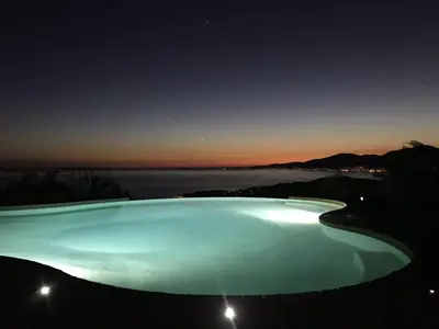 a large pool of blue water at night at Sole Rossu in Albitreccia