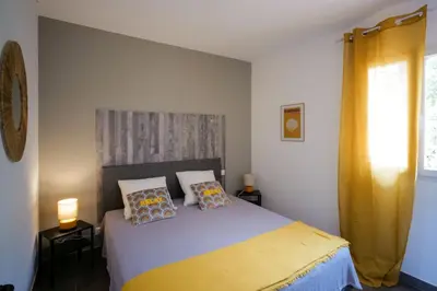 a bedroom with a bed with two pillows on it at SOLE DI DUME in Sotta