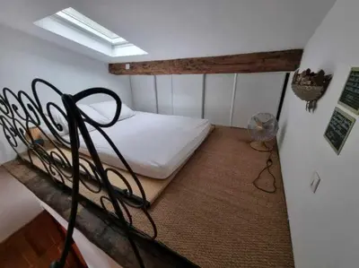 a bedroom with a bunk bed and a fan at mare-monte in Evisa