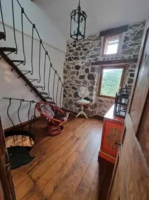 a room with a staircase and a stone wall at mare-monte in Evisa