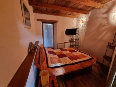 a bedroom with a bed and a television in a room at mare-monte in Evisa