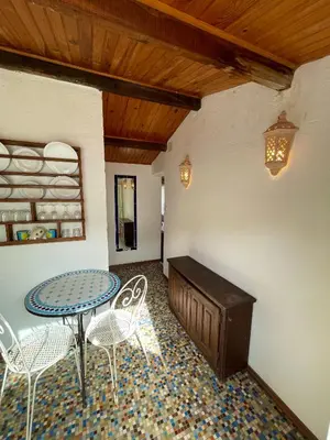 a patio with a table and chairs in a room at Residence VILLA MOROSI - Favone in Conca