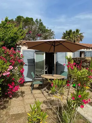 a patio with an umbrella and a table and chairs at Residence VILLA MOROSI - Favone in Conca