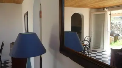 a mirror with a blue lamp in a room at Residence VILLA MOROSI - Favone in Conca