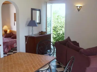 a living room with a couch and a table and a bed at Residence VILLA MOROSI - Favone in Conca