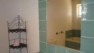 a bathroom with a mirror and a bath tub at Residence VILLA MOROSI - Favone in Conca
