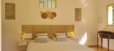 a bedroom with a large bed with two pillows at Prea Gianca in Bonifacio