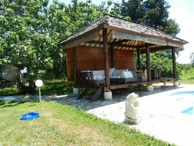 a wooden gazebo on a patio in a yard at Monica di Sorbo in Sorbo-Ocagnano