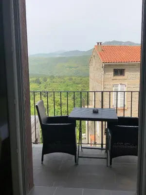 a view of a balcony with a table and chairs at A Fontana in Zonza