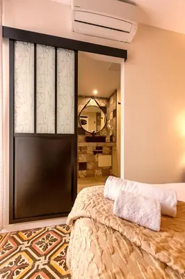 a bedroom with a bed and a large window at A Fontana in Zonza