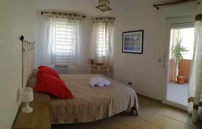 a bedroom with a bed with a stuffed animal on it at Les princes du golf Jerome numero 13 quartier pascal paoli Appartement in Porto-Vecchio