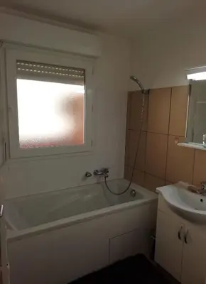 a bathroom with a bath tub and a sink at Les princes du golf Jerome numero 13 quartier pascal paoli Appartement in Porto-Vecchio