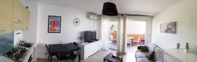 a living room with a couch and a table and a television at Les princes du golf Jerome numero 13 quartier pascal paoli Appartement in Porto-Vecchio