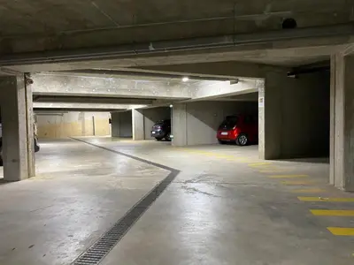 a parking garage with two cars parked in it at Suite Home Porticcio in Porticcio