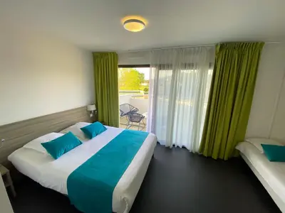 a bedroom with a large bed with blue pillows at Suite Home Porticcio in Porticcio