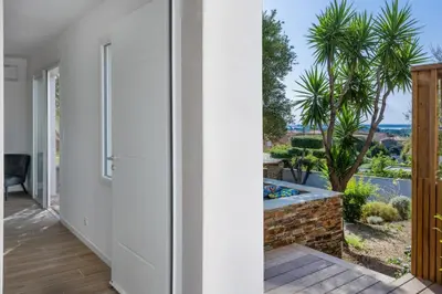 a hallway of a house with a view of a garden at Villa Le Corps de Garde in Furiani