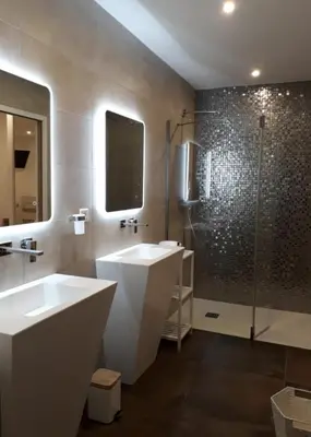 a bathroom with two sinks and a shower at L'oliveraie du Fango in Manso