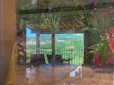 a living room with a couch and a view at Résidence Maora Village in Bonifacio