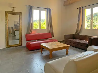 a living room with a couch and a coffee table at Résidence Maora Village in Bonifacio