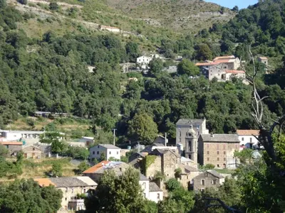 a town on a hill with houses and trees at Hotel U Liccedu in Bustanico