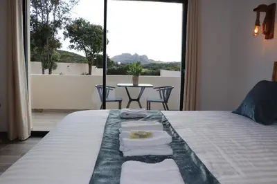 a bedroom with a bed with towels on it at Hotel Fazio in Bonifacio