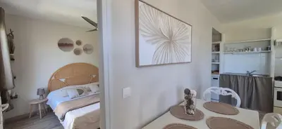 a bedroom with a bed and a table with a mirror at Gîte A l'ombre du clocher in Calenzana