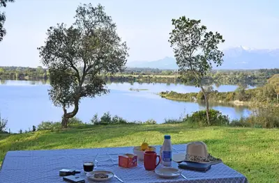 a picnic table with a view of a lake at Locations 