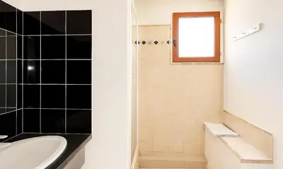 a bathroom with a sink and a toilet and a tub at Locations 