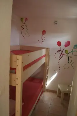 a childs room with a bunk bed with balloons on the wall at Hameau de pietra longa Salvini PORTO-VECCHIO in Sotta