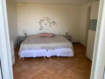 a bedroom with a bed in a room at Hameau de pietra longa Salvini PORTO-VECCHIO in Sotta