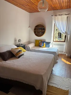 a bedroom with a bed and a dresser and a chandelier at Maison de village in Ortiporio