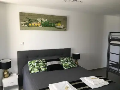 a bedroom with a bed and a painting on the wall at Casa di Emma in Santo-Pietro-di-Tenda