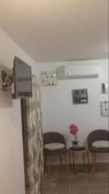 a waiting room with chairs and a flat screen tv at Casa di Emma in Santo-Pietro-di-Tenda