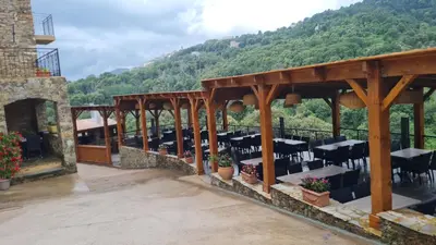 a patio with tables and chairs on a mountain at A COSTA in Venzolasca