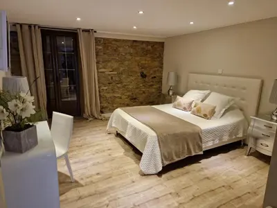 a bedroom with a bed and a table with a chair at A COSTA in Venzolasca
