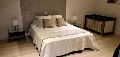 a bedroom with a large white bed with pillows and a piano at A COSTA in Venzolasca