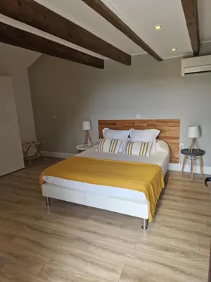 a bedroom with a large bed with a wooden headboard at A COSTA in Venzolasca