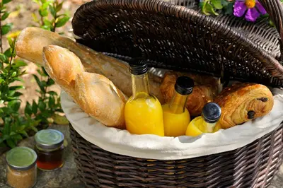 a basket filled with bread and bottles of wine at Résidence Arco Plage in Olmeto