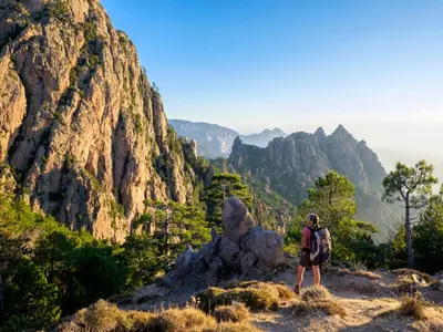 a man standing on top of a mountain at Résidence Arco Plage in Olmeto