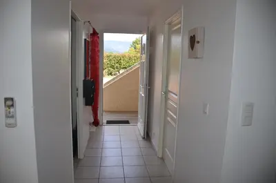 a hallway with a door leading to a room with a view at Appt T2 Standing avec Piscine et Terrasse in Porto-Vecchio