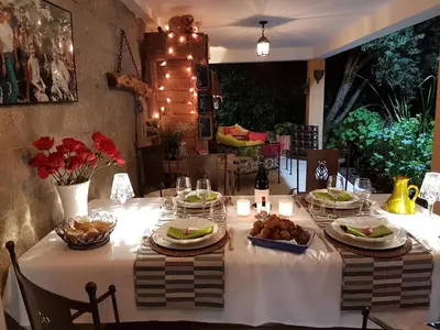 a table with a white table cloth with food on it at la VILLA GUIDI in Pila-Canale