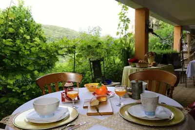 a table with plates and cups and wine glasses on it at la VILLA GUIDI in Pila-Canale