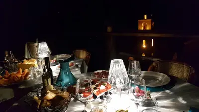 a table with wine glasses and food on it at la VILLA GUIDI in Pila-Canale