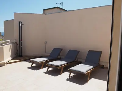 three blue chairs sitting on top of a roof at Appartement toit terrasse 2 chambres in Ajaccio