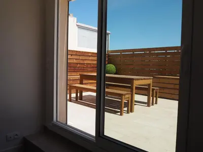 a view from a window of a patio with a table and bench at Appartement toit terrasse 2 chambres in Ajaccio