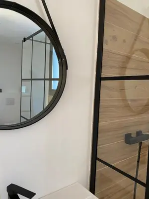 a mirror on a wall next to a stair case at LA POINTE D’ASPRETTO in Ajaccio